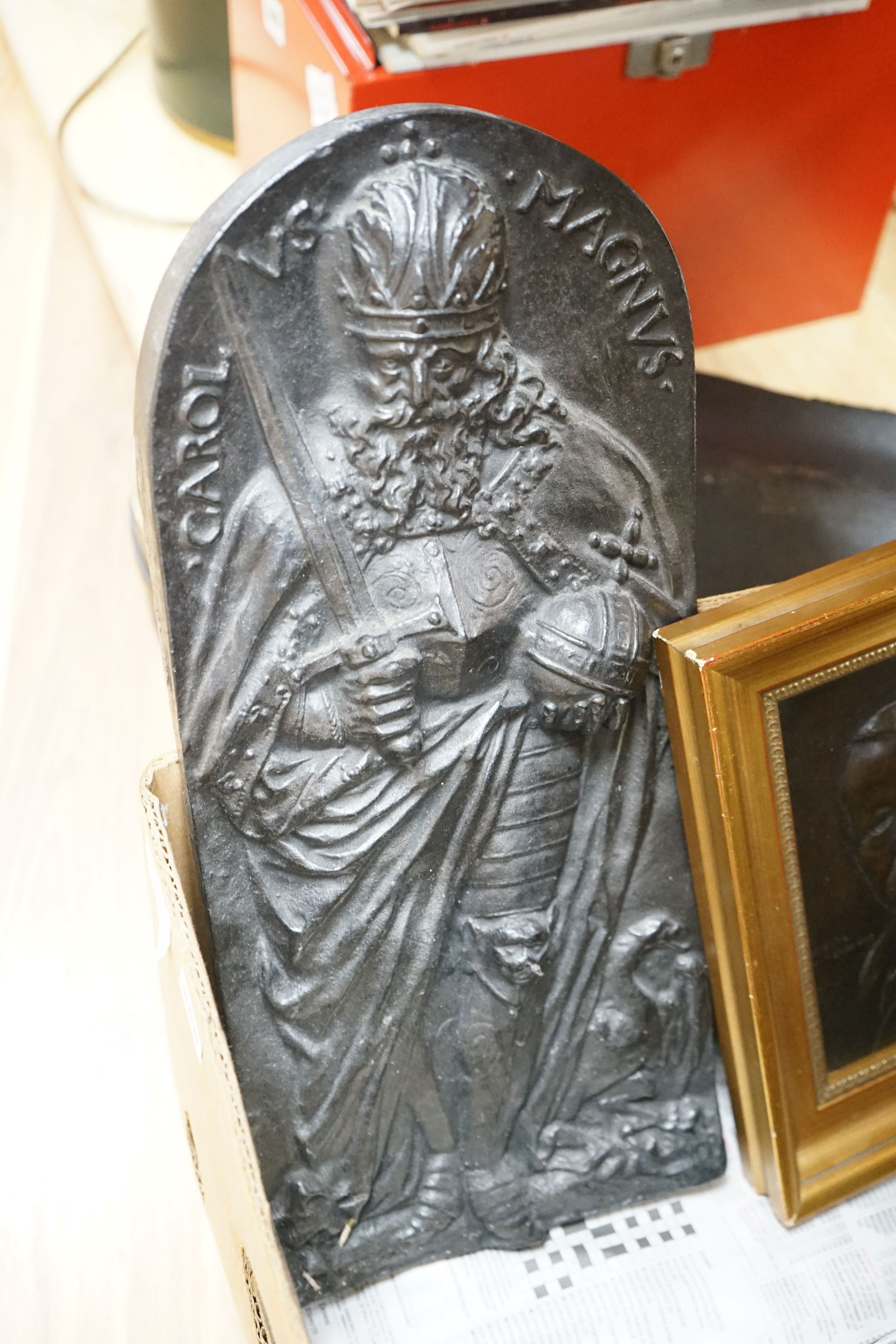 Nine relief plaques, a carved panel and a bronze style putti mounted on wooden panel